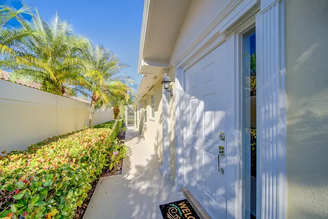 a yellow plant in front of a door