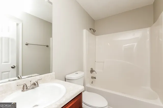 a bathroom with a toilet and a bath tub