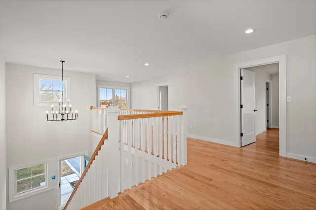 an empty room with wooden floor and window