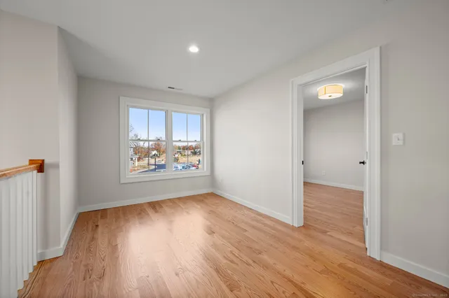 a view of a room with wooden floor
