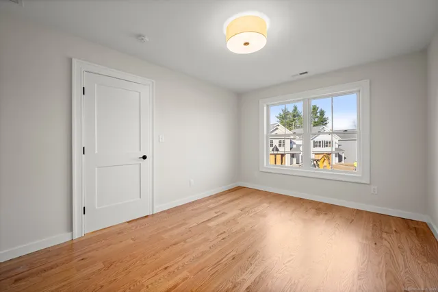 a view of a room with wooden floor and window