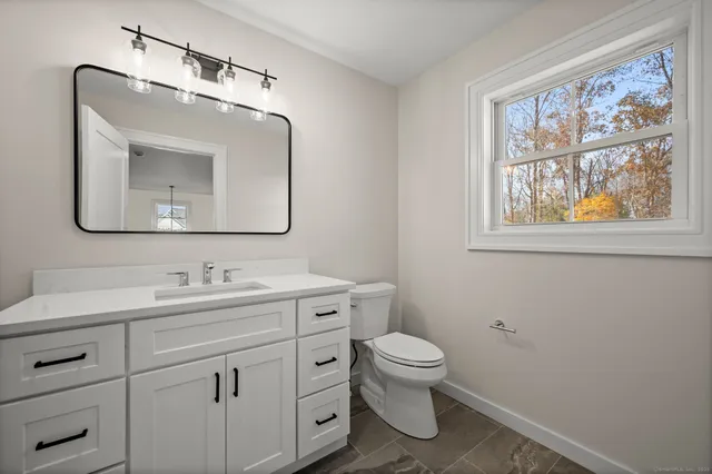 a bathroom with a tub sink and mirror
