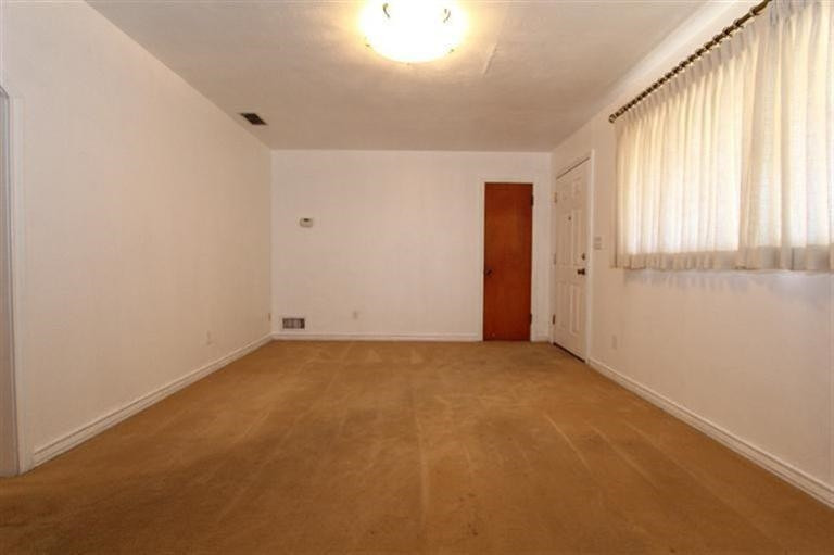 3004 36th Street Lubbock, TX 79413 - Photo 2 of 10 an empty room with windows