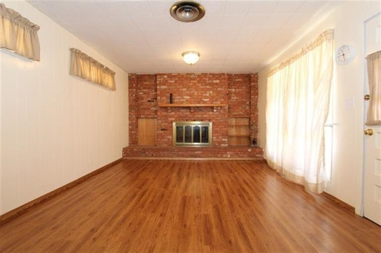 3004 36th Street Lubbock, TX 79413 - Photo 3 of 10 an empty room with wooden floor and windows