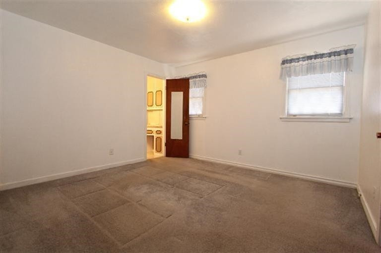 3004 36th Street Lubbock, TX 79413 - Photo 7 of 10 an empty room with windows and closet