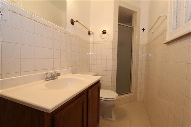 3004 36th Street Lubbock, TX 79413 - Photo 8 of 10 a bathroom with a sink a toilet and shower