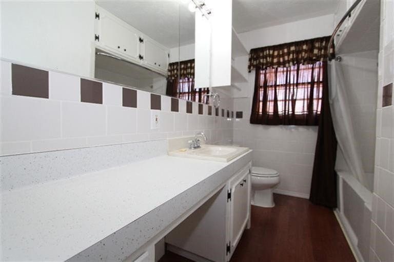 3004 36th Street Lubbock, TX 79413 - Photo 10 of 10 a bathroom with a sink a toilet and a window