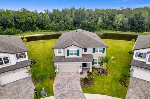aerial view of a house with pool and a yard