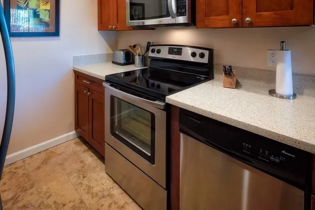 a kitchen with a stove microwave and sink