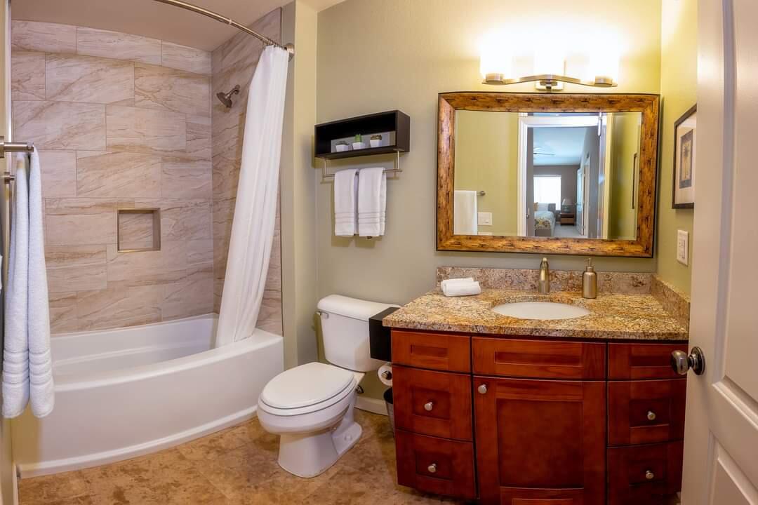 351 North Hermosa Drive, Unit 2A2 Palm Springs, CA 92262 - Photo 9 of 17 a bathroom with a granite countertop sink toilet a mirror and bathtub