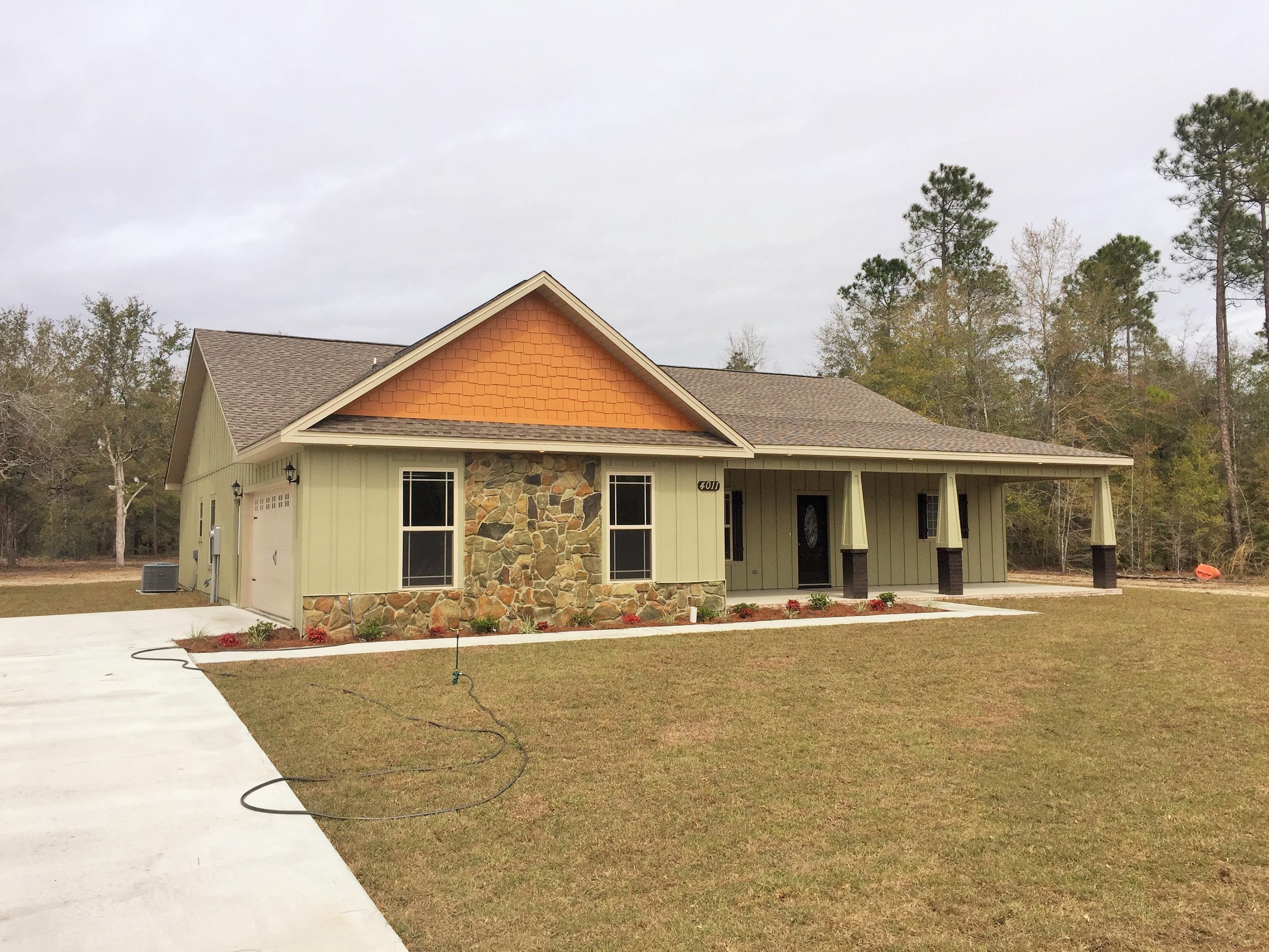 4011 Happy Trails Road Crestview, FL 32539 - Photo 1 of 19 a front view of house with yard and trees in the background