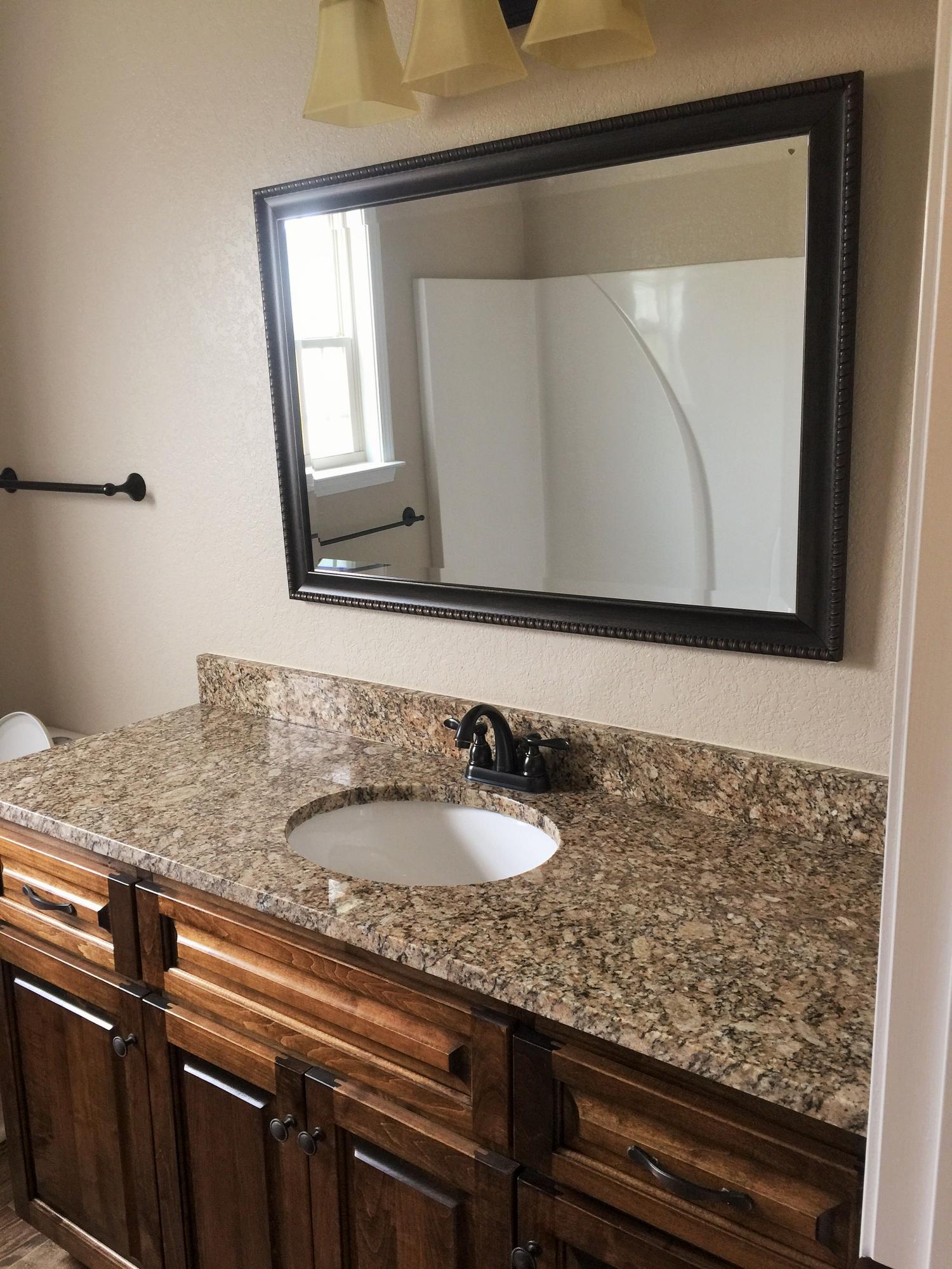4011 Happy Trails Road Crestview, FL 32539 - Photo 17 of 19 a bathroom with a sink and a mirror