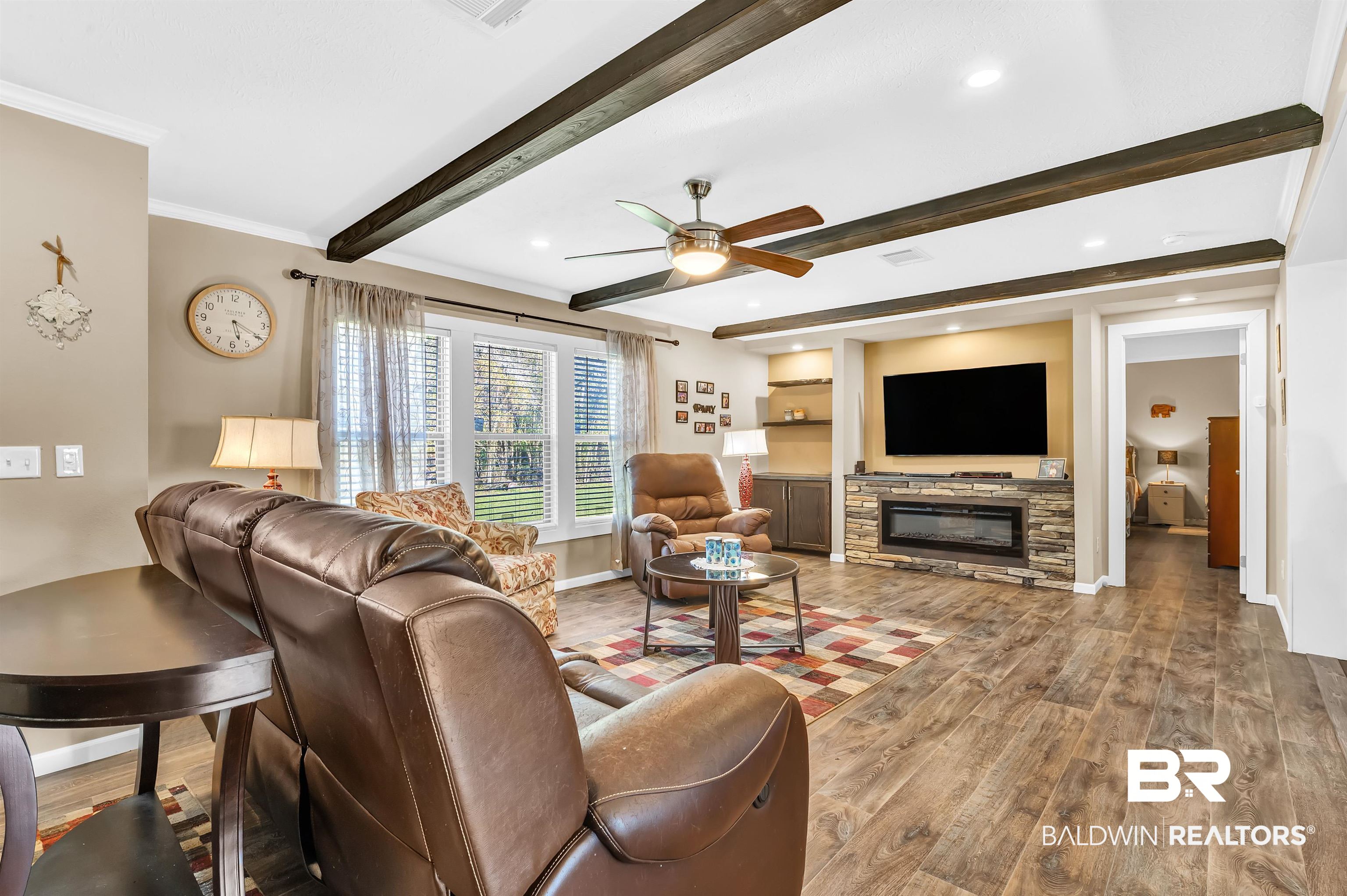 23233 Forland Road Silverhill, AL 36576 - Photo 9 of 33 Living area with crown molding, baseboards, beamed ceiling, a ceiling fan, and wood finished floors