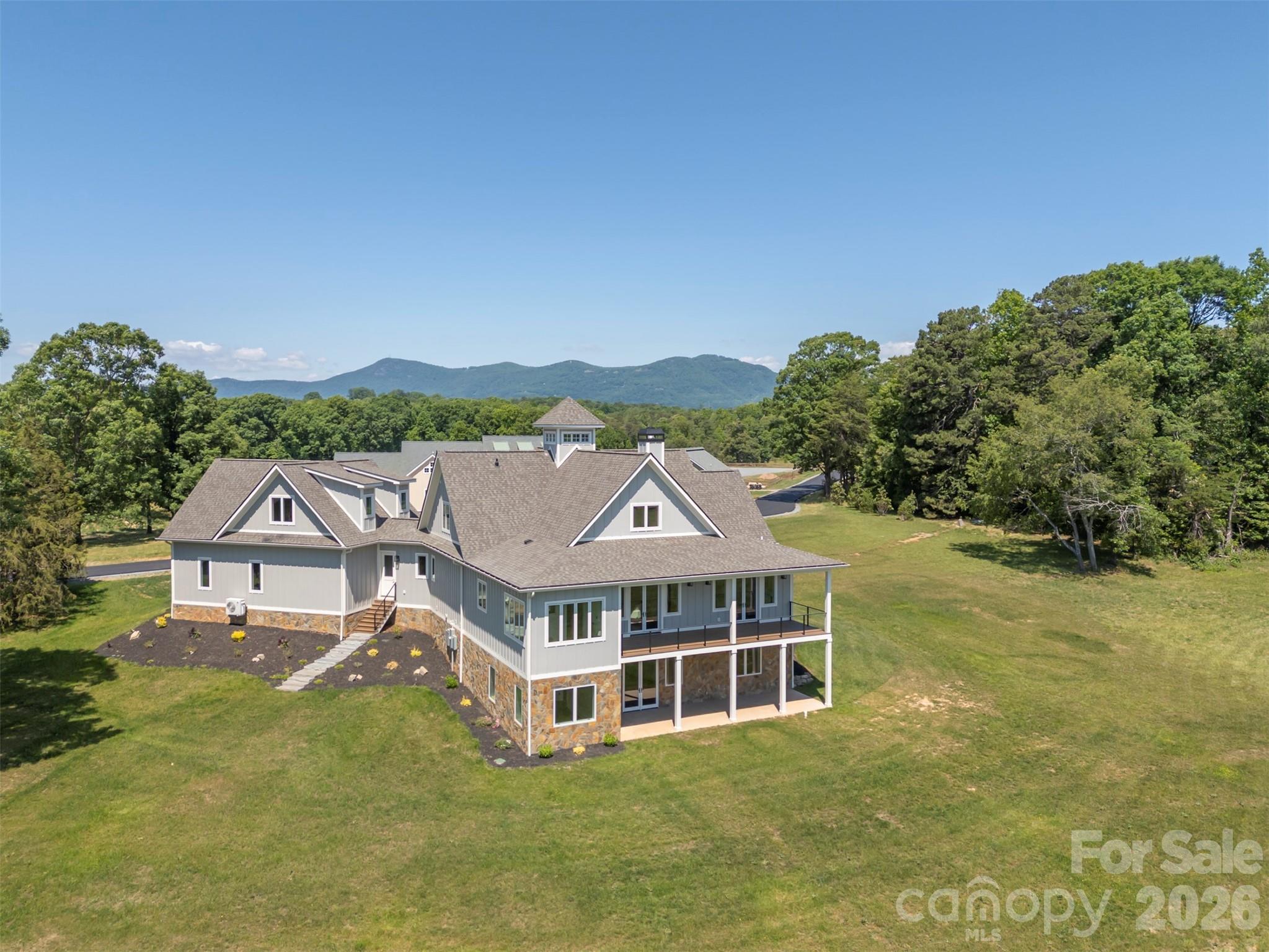297 Mountain Meadows Lane, Unit 7 Tryon, NC 28782 - Photo 2 of 47 an aerial view of residential houses and trees in the background