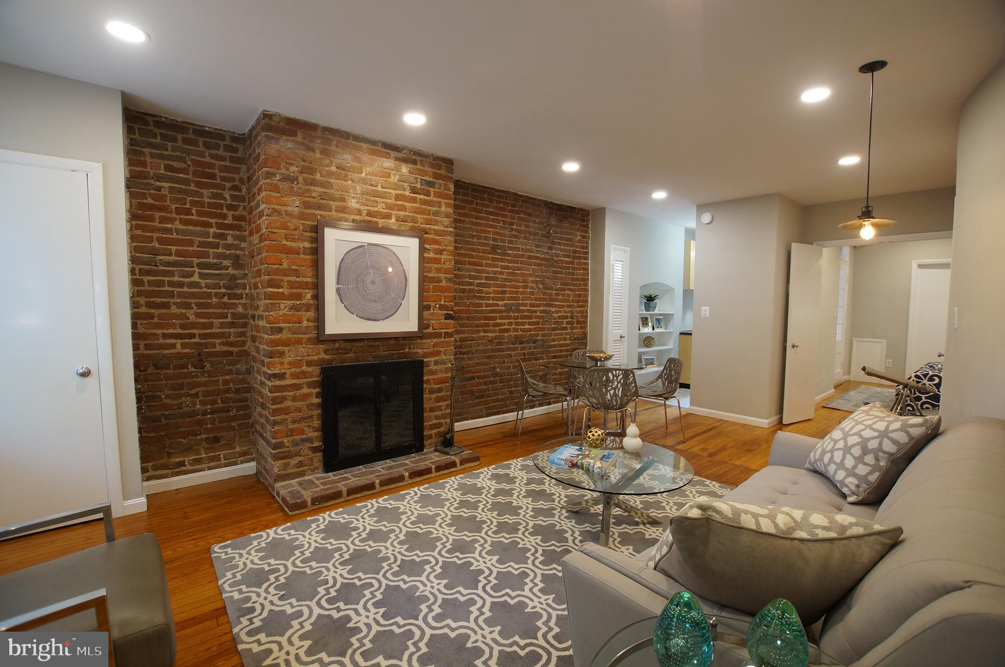 633 A Street Northeast Washington, DC 20002 - Photo 34 of 56 High ceiling, brick fireplace, wood floors...