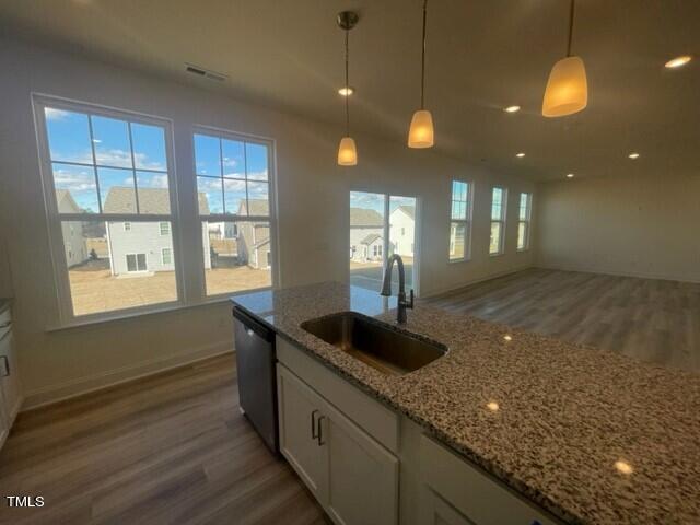 912 Channel Drop Loop Zebulon, NC 27597 - Photo 13 of 25 a kitchen with granite countertop sink and cabinets