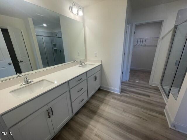 912 Channel Drop Loop Zebulon, NC 27597 - Photo 17 of 25 a bathroom with a double vanity sink and mirror