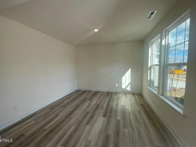 912 Channel Drop Loop Zebulon, NC 27597 - Photo 4 of 25 wooden floor in an empty room with a window