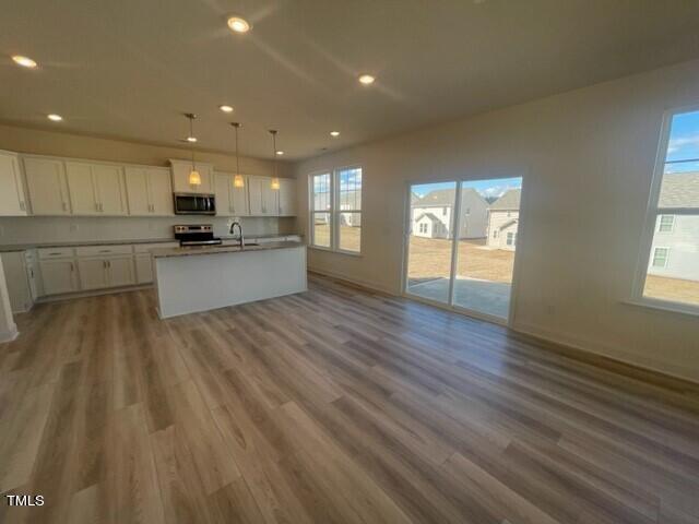 912 Channel Drop Loop Zebulon, NC 27597 - Photo 9 of 25 a large kitchen with a lot of counter space and a wooden floor