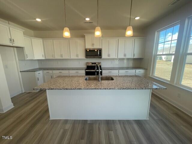 912 Channel Drop Loop Zebulon, NC 27597 - Photo 10 of 25 an open kitchen with kitchen island and large window