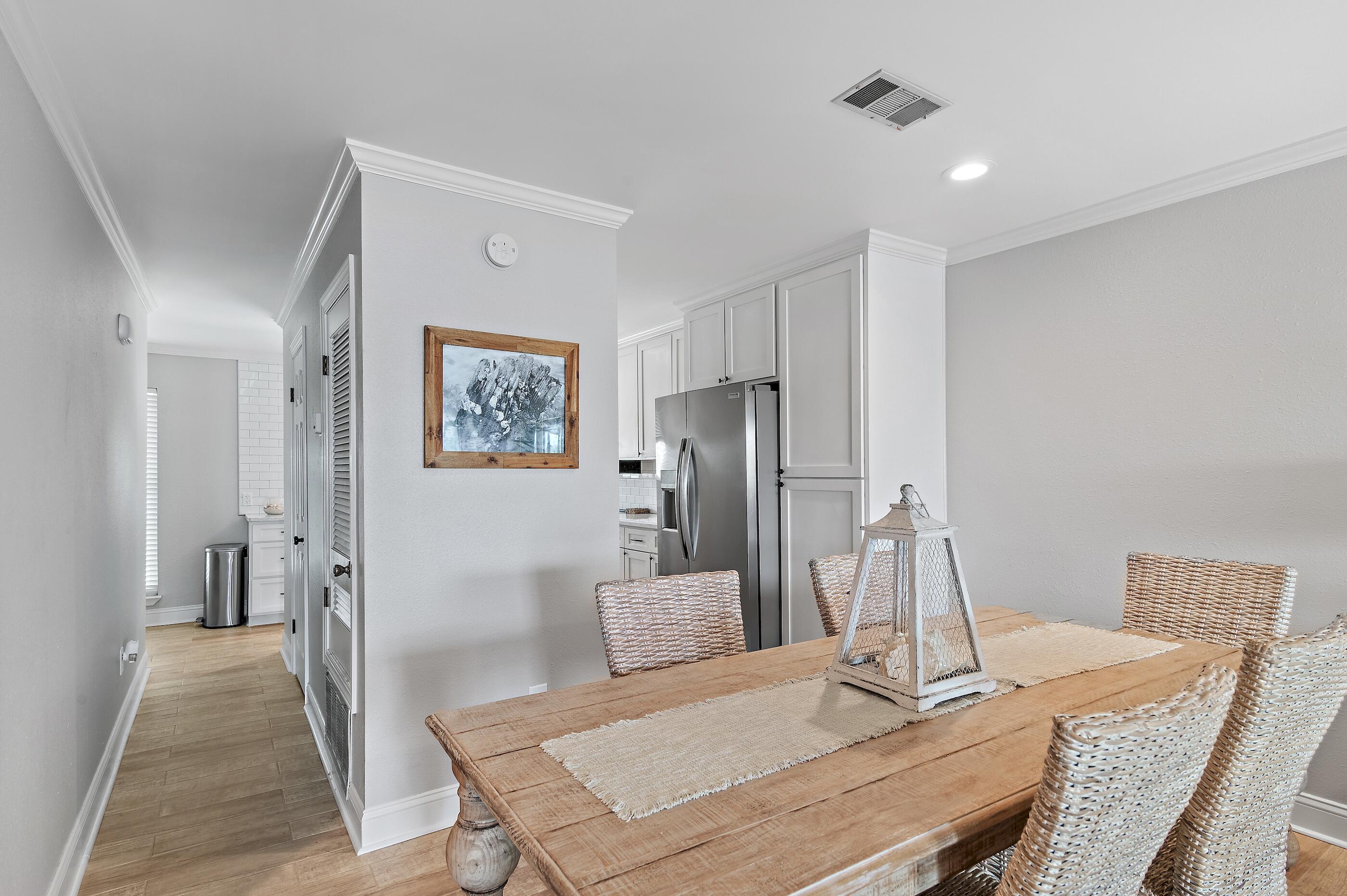 169 Durango Road Destin, FL 32541 - Photo 13 of 39 a living room with stainless steel appliances furniture a refrigerator and a dining table