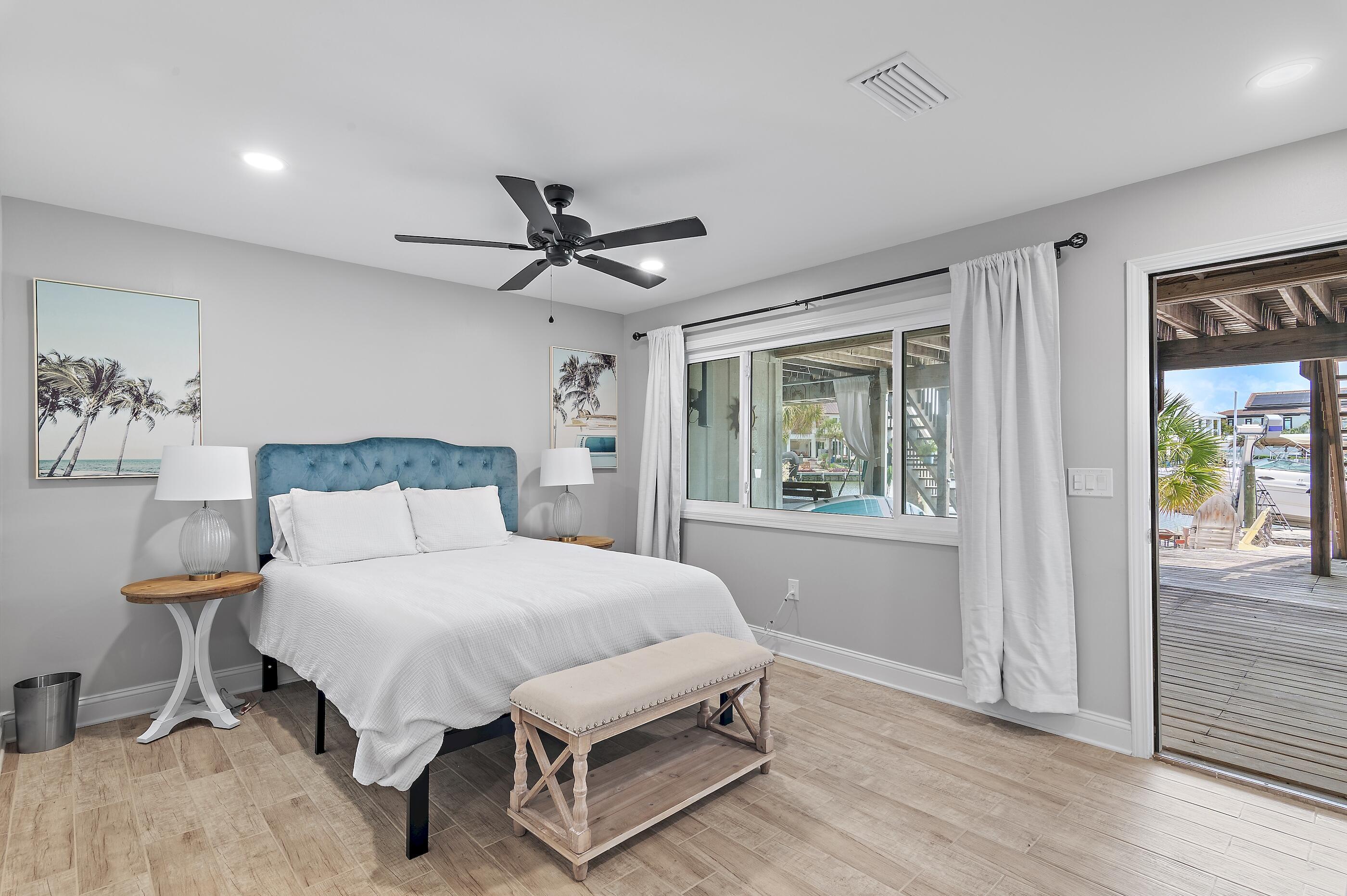 169 Durango Road Destin, FL 32541 - Photo 17 of 39 a bedroom with a bed a window and a chandelier