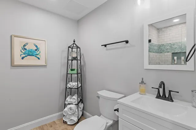 a bathroom with a toilet a sink and window