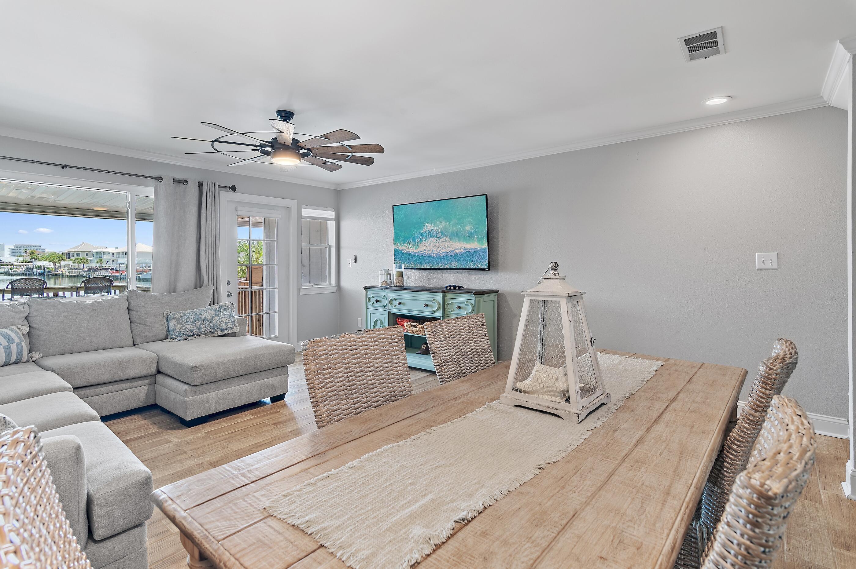 169 Durango Road Destin, FL 32541 - Photo 2 of 39 a living room with furniture two large window and a chandelier