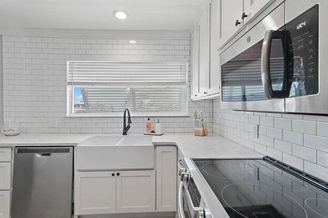 a kitchen with a sink cabinets and window