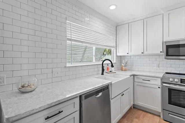 a kitchen with a sink cabinets and window