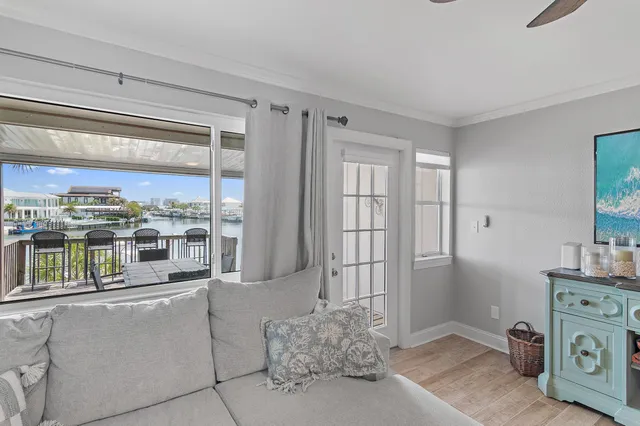 a room with stainless steel appliances kitchen island granite countertop a refrigerator and a wooden cabinets