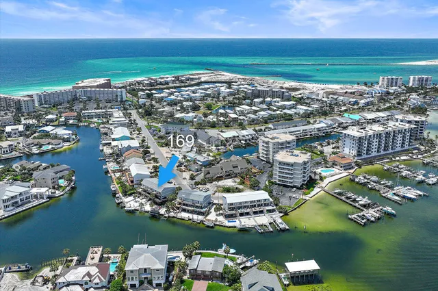 an aerial view of a city with lots of residential buildings and ocean view