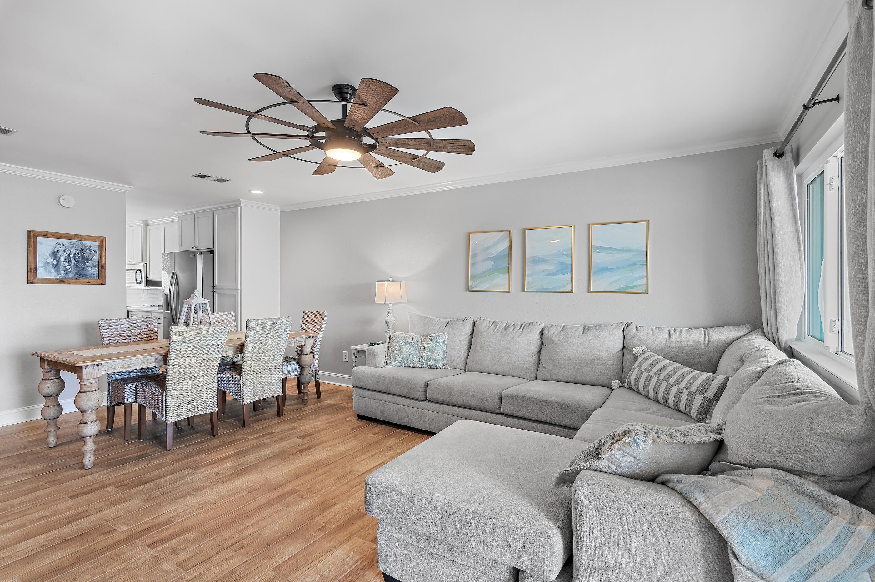 169 Durango Road Destin, FL 32541 - Photo 10 of 39 a living room with furniture a wooden floor and a chandelier