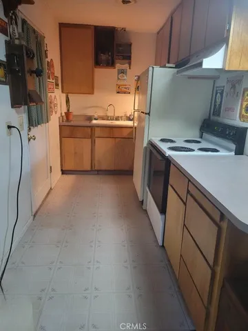 a kitchen with stainless steel appliances and white cabinets