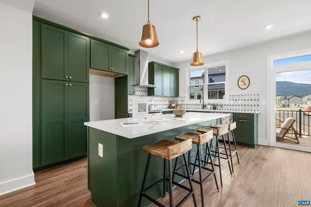 a kitchen with stainless steel appliances a table chairs and chandelier