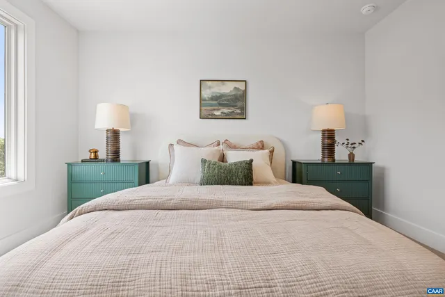 a bedroom with a bed and a lamp