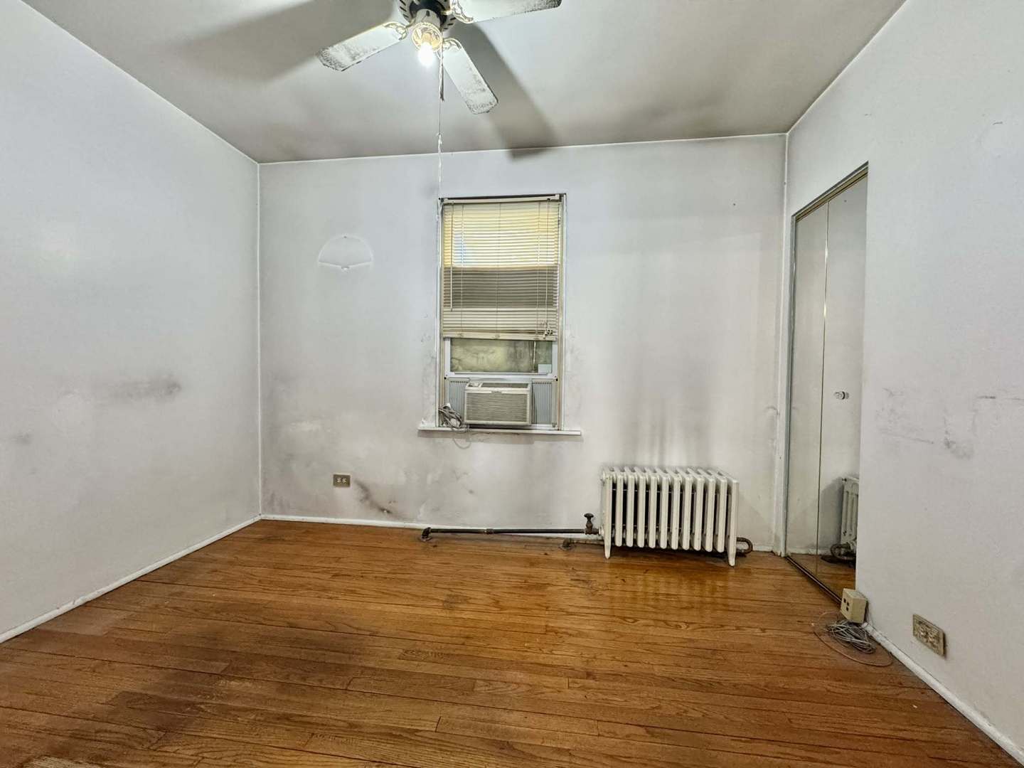 5437 North Linder Avenue Chicago, IL 60630 - Photo 8 of 28 an empty room with wooden floor and windows