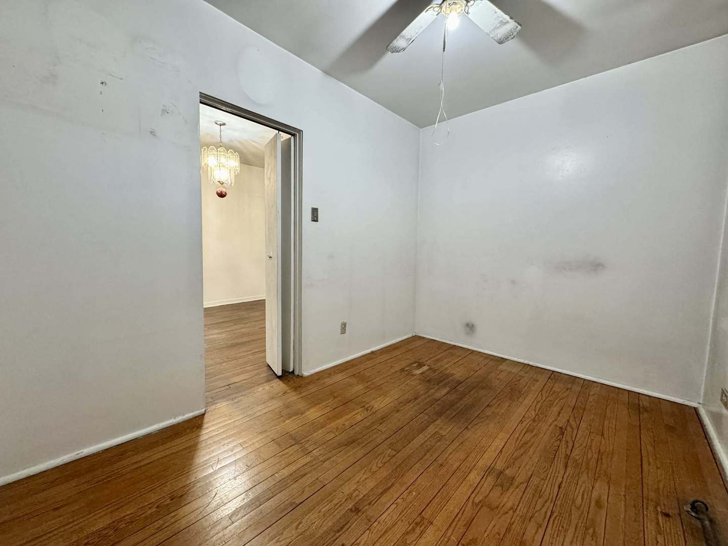 5437 North Linder Avenue Chicago, IL 60630 - Photo 9 of 28 an empty room with wooden floor and chandelier fan