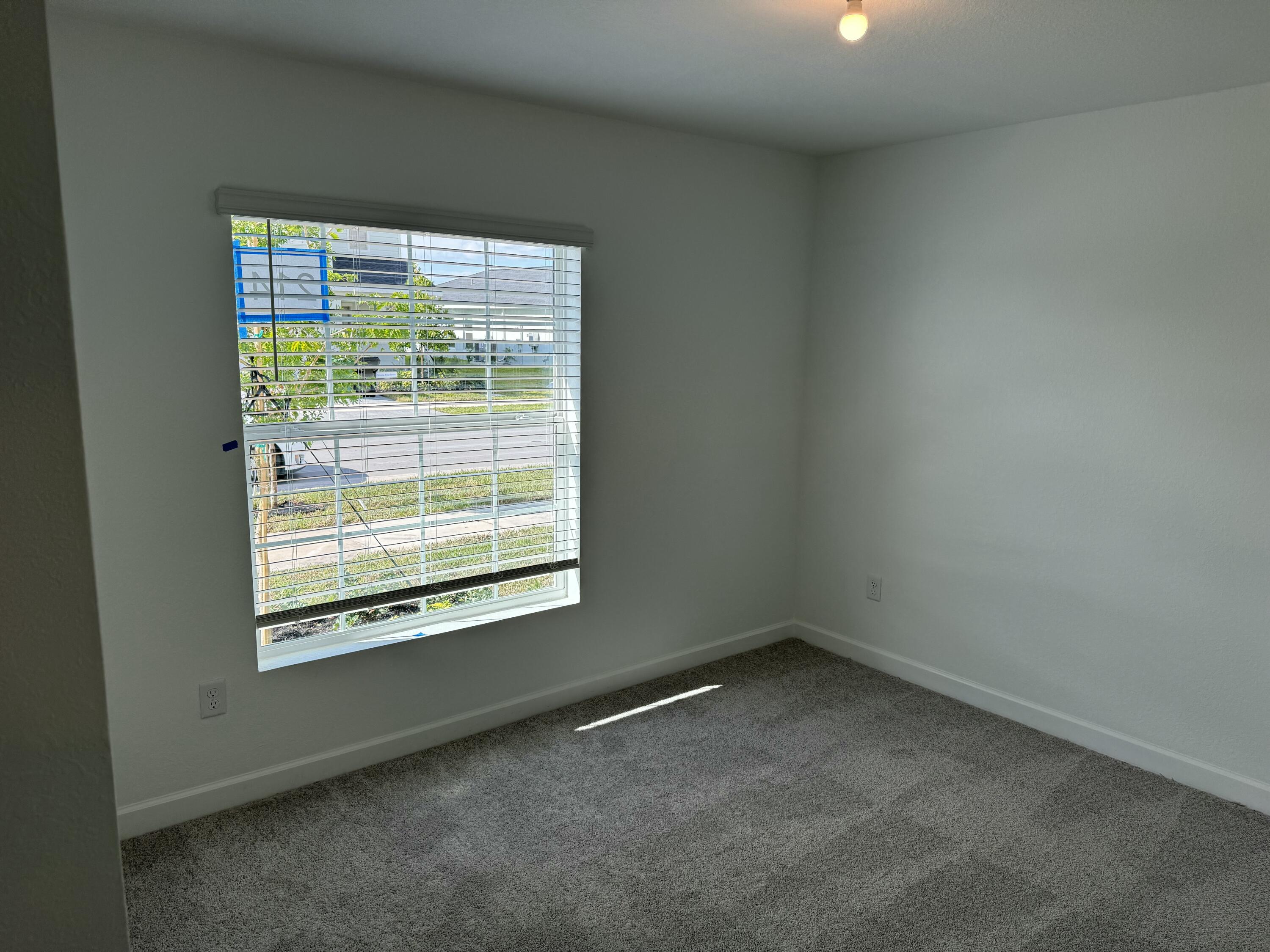 10445 Northwest Suncrest Loop Port Port St. Lucie, FL 34987 - Photo 11 of 45 a view of an empty room with a window