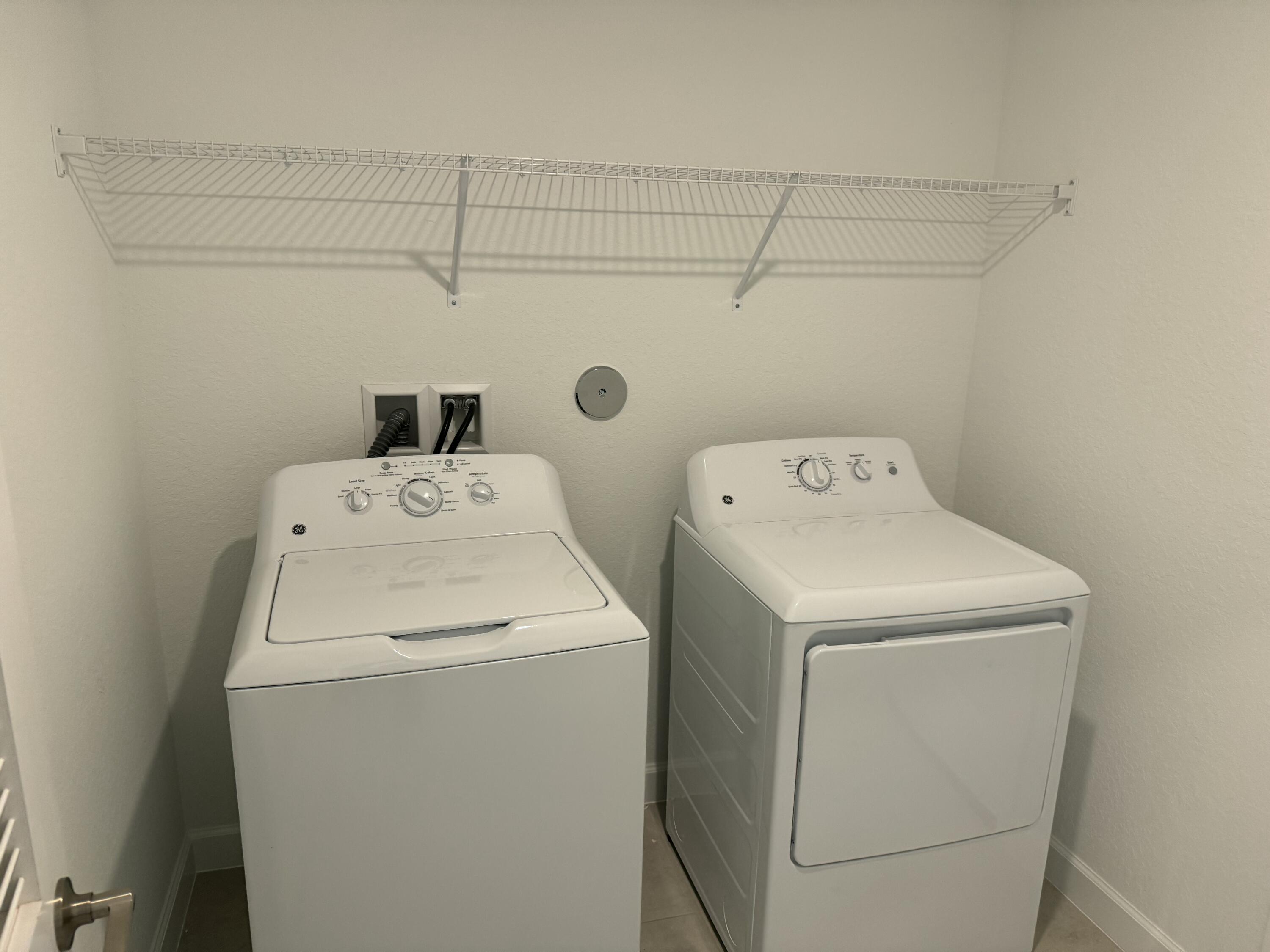 10445 Northwest Suncrest Loop Port Port St. Lucie, FL 34987 - Photo 13 of 45 a utility room with dryer and washer