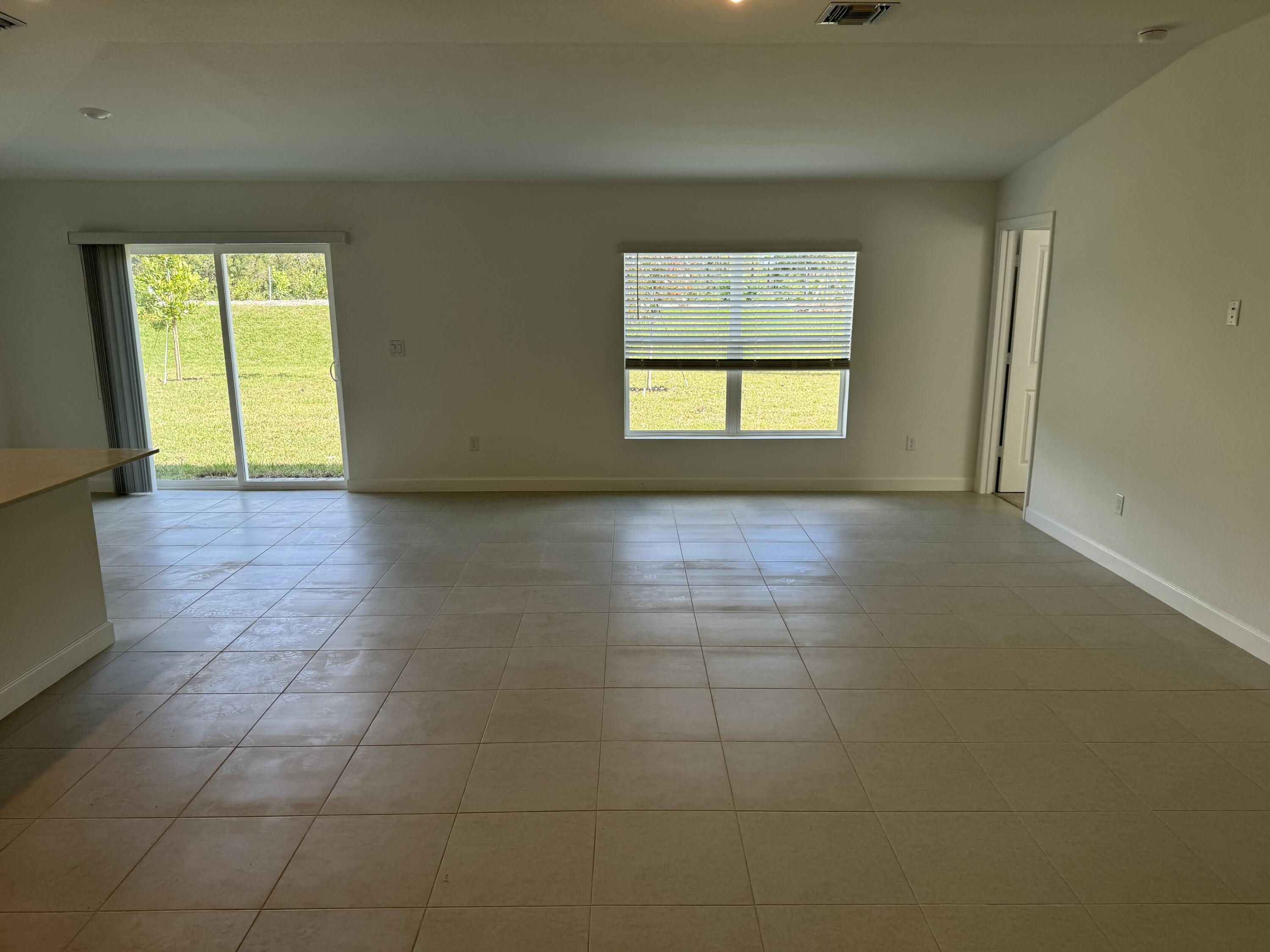 10445 Northwest Suncrest Loop Port Port St. Lucie, FL 34987 - Photo 15 of 45 a view of an empty room with a window