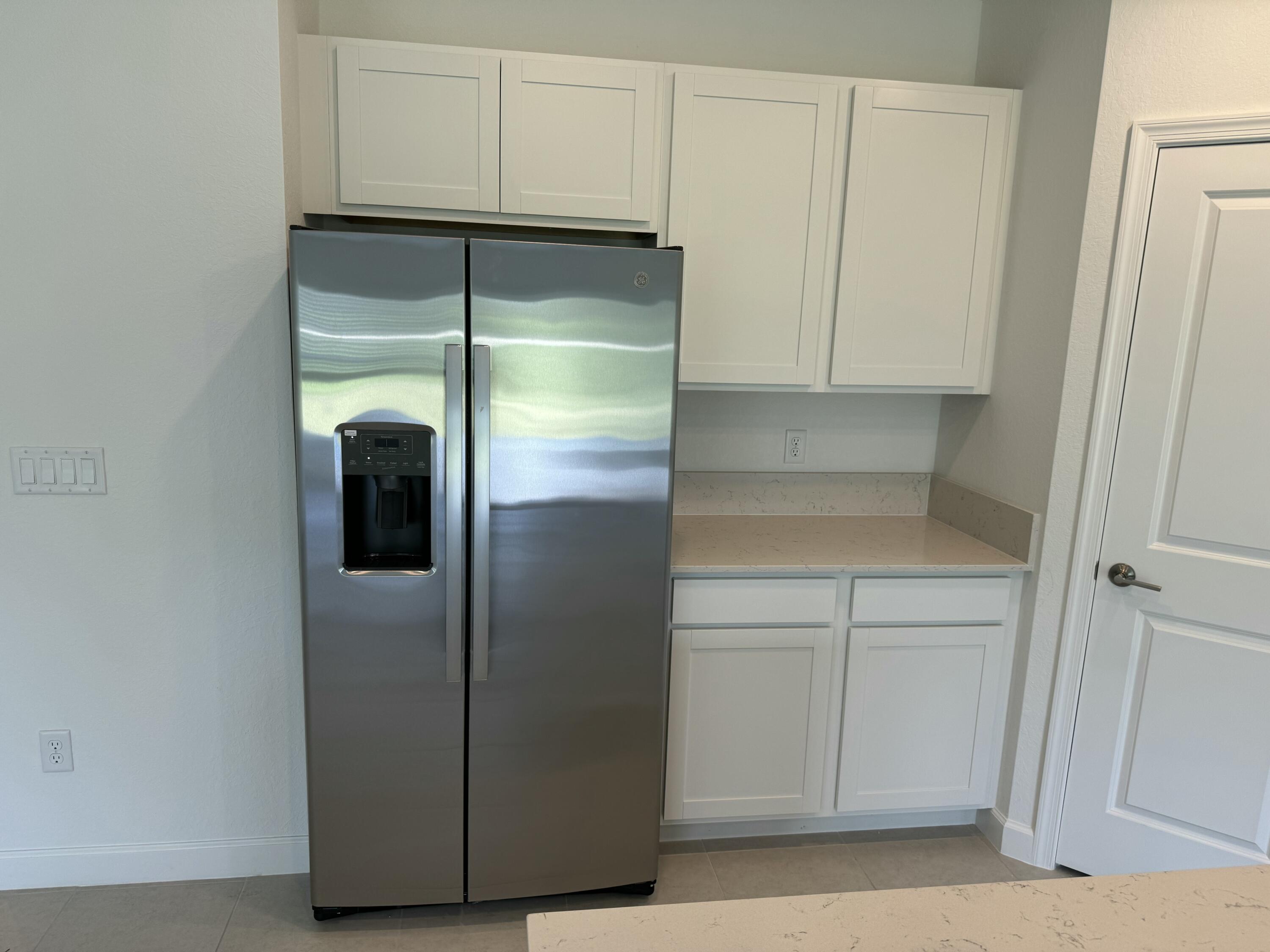 10445 Northwest Suncrest Loop Port Port St. Lucie, FL 34987 - Photo 19 of 45 a close view of a refrigerator in kitchen