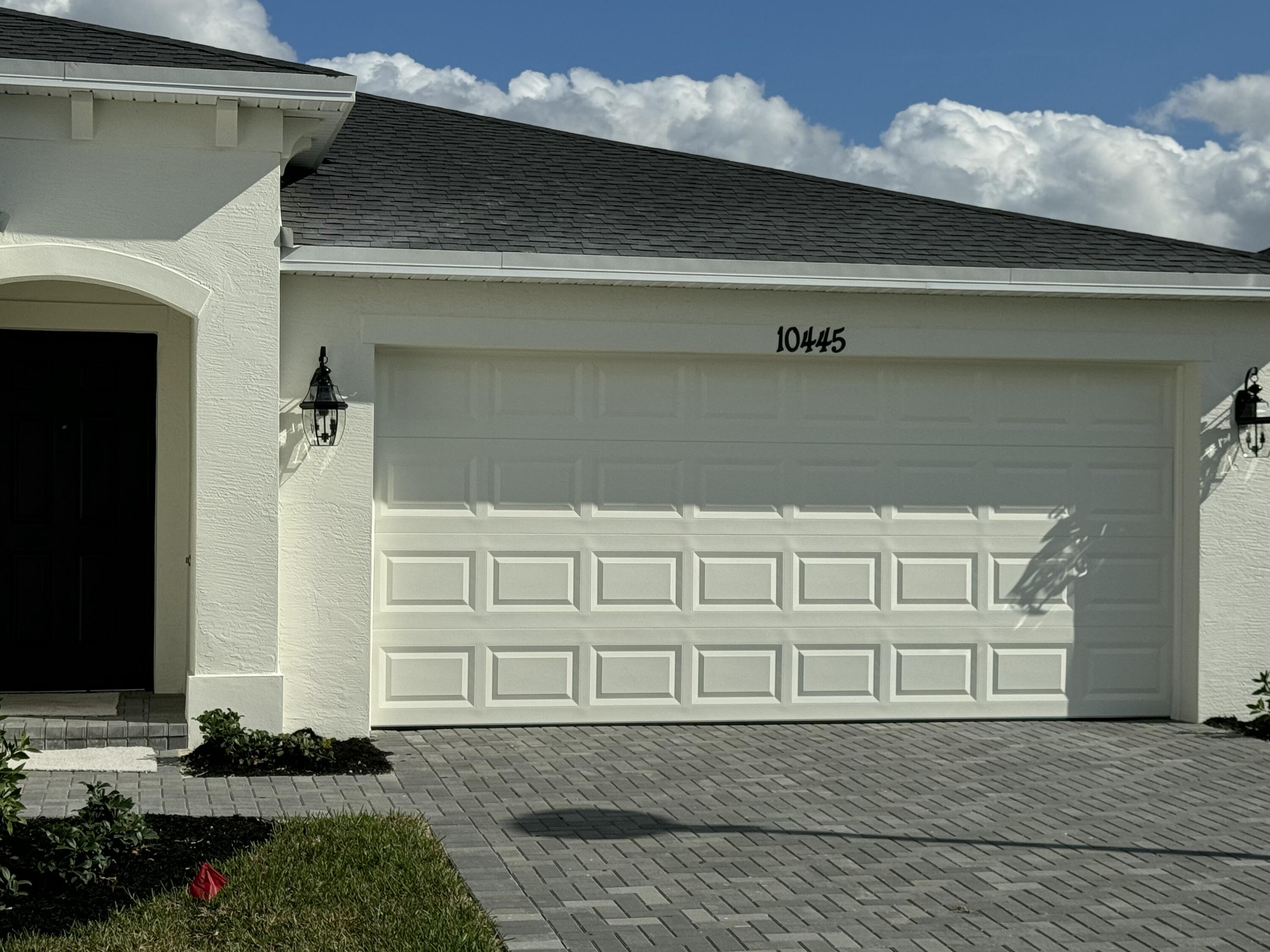 10445 Northwest Suncrest Loop Port Port St. Lucie, FL 34987 - Photo 2 of 45 a front view of a house