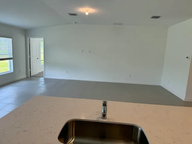 a view of an empty room and wooden floor
