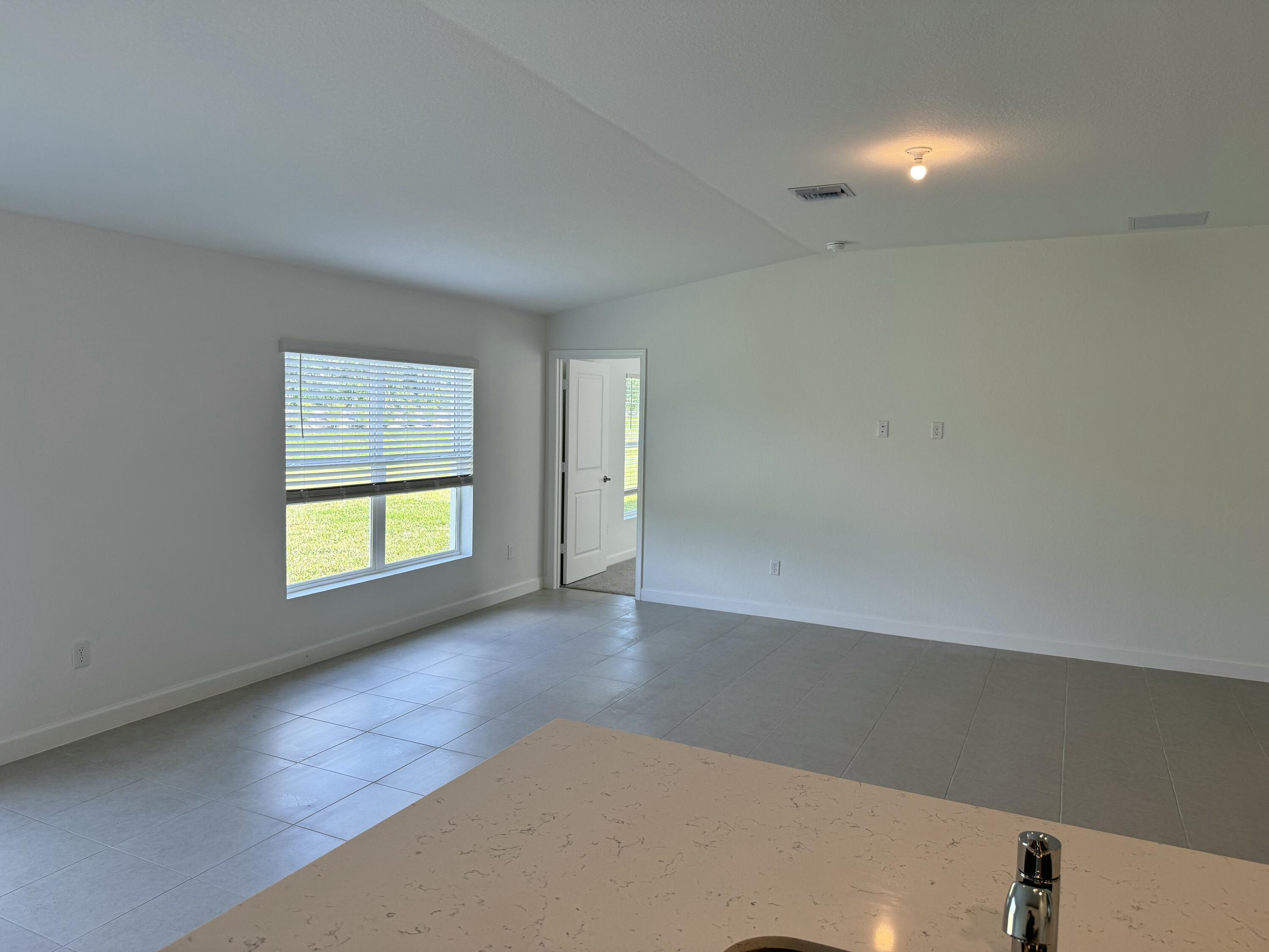 10445 Northwest Suncrest Loop Port Port St. Lucie, FL 34987 - Photo 22 of 45 an empty room with a window