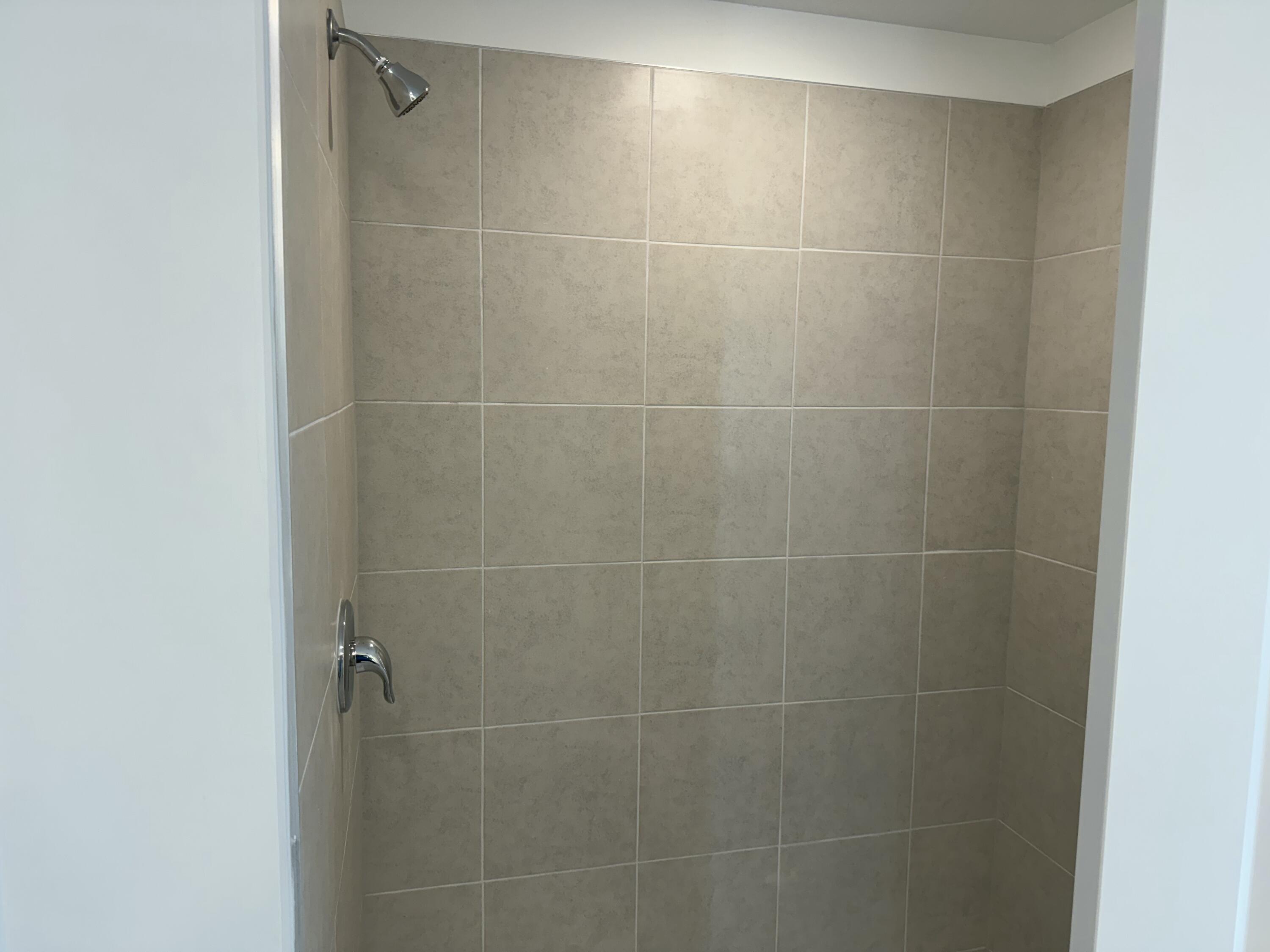 10445 Northwest Suncrest Loop Port Port St. Lucie, FL 34987 - Photo 26 of 45 a bathroom with a shower