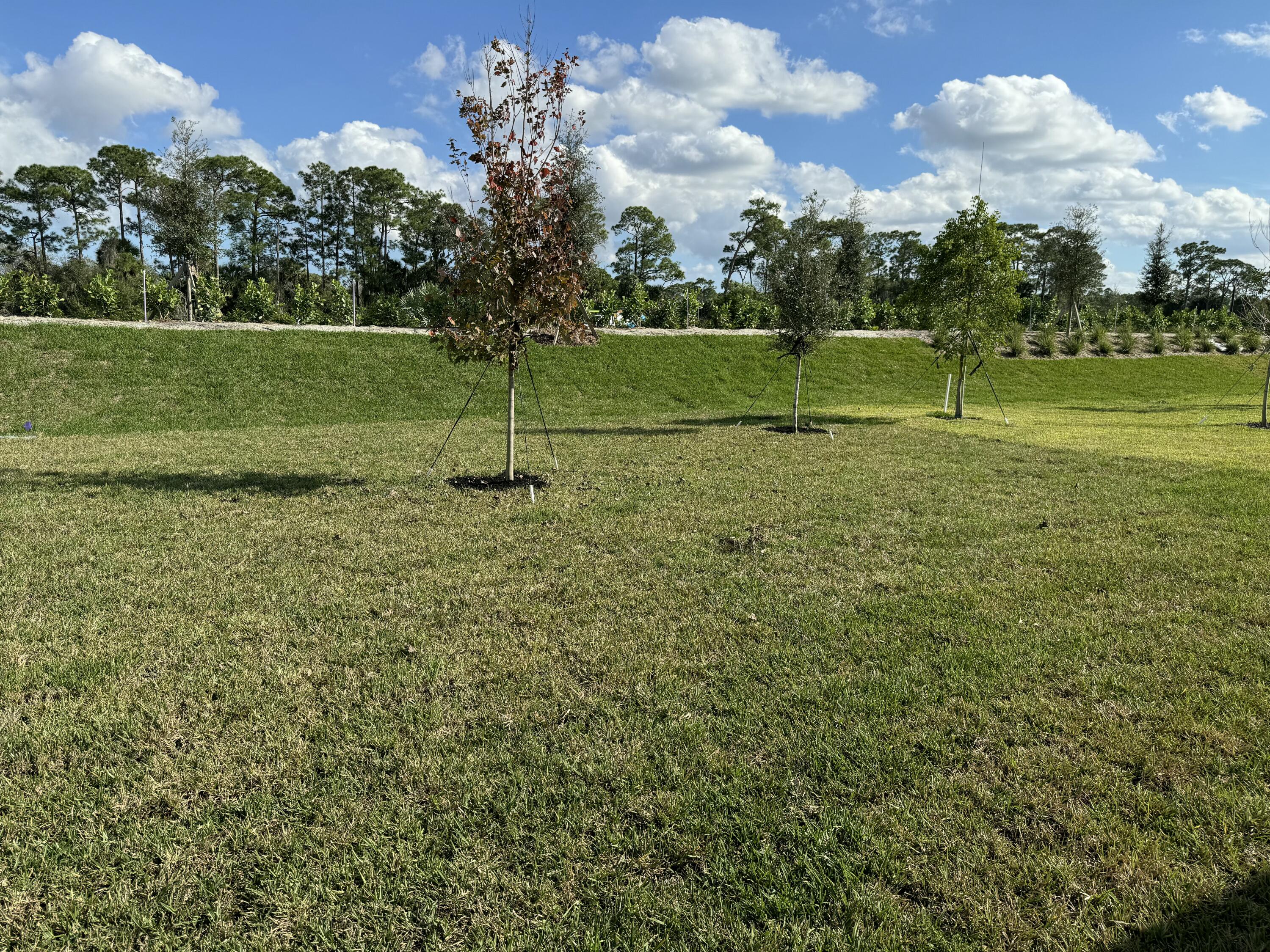 10445 Northwest Suncrest Loop Port Port St. Lucie, FL 34987 - Photo 32 of 45 a view of a golf course with a lake