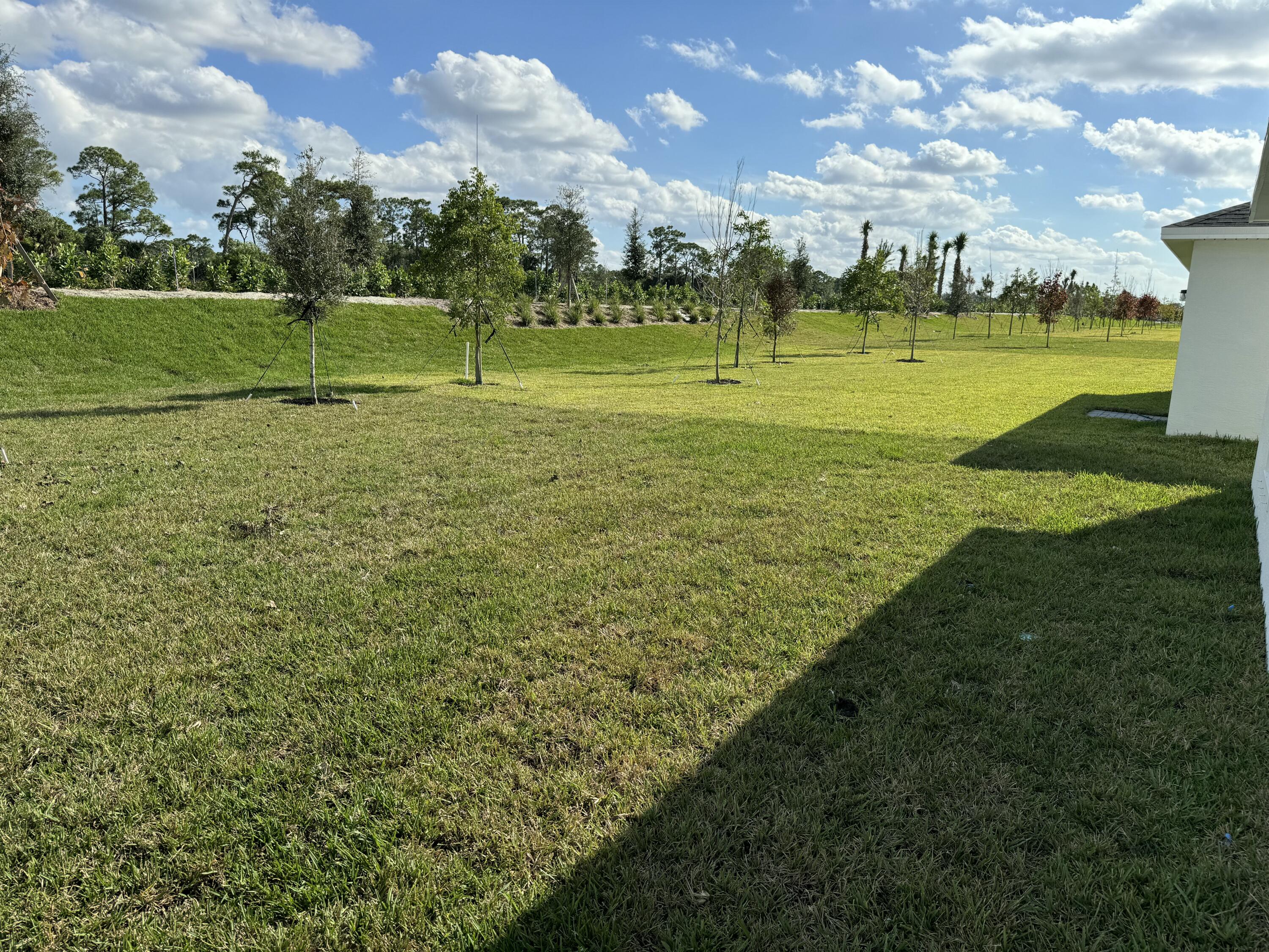 10445 Northwest Suncrest Loop Port Port St. Lucie, FL 34987 - Photo 33 of 45 a view of a golf course with a lake