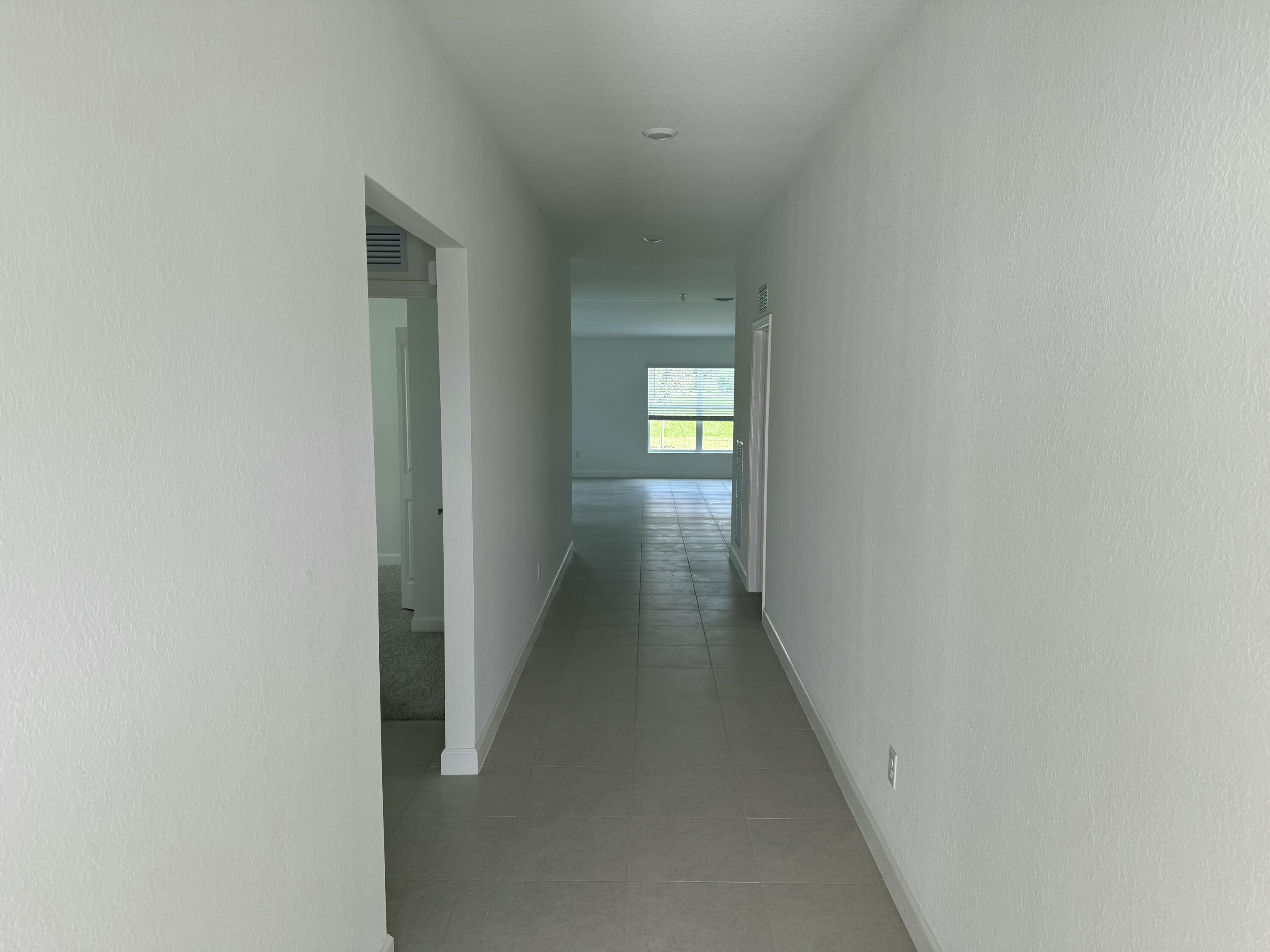 10445 Northwest Suncrest Loop Port Port St. Lucie, FL 34987 - Photo 5 of 45 a view of hallway with wooden floor