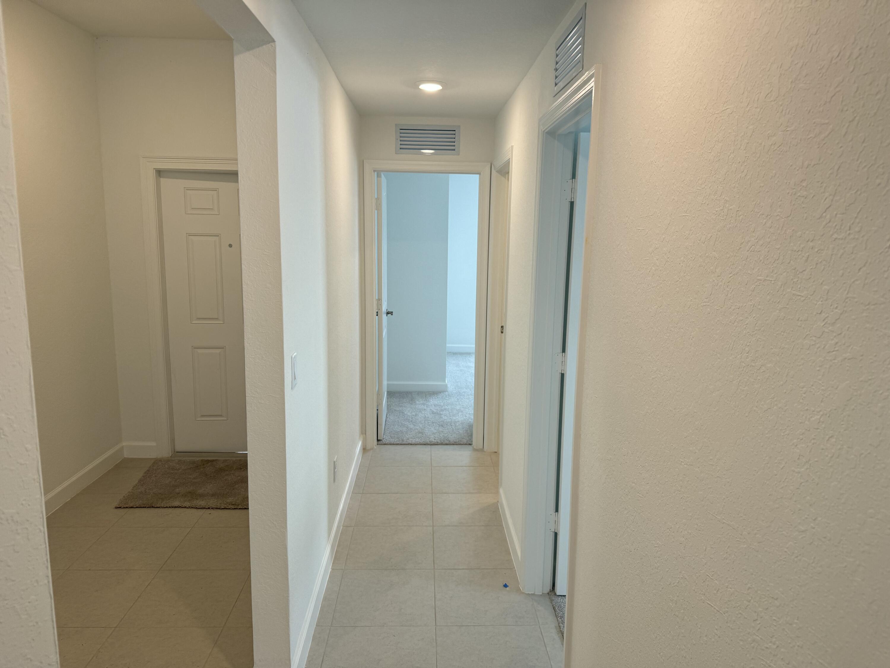 10445 Northwest Suncrest Loop Port Port St. Lucie, FL 34987 - Photo 8 of 45 a view of hallway with shower